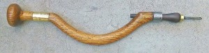 Diminutive oak brace, 4" sweep, accepting round pads. In the form of a crooked stick type brace, but the grain is quite straight.