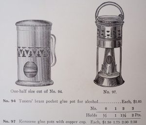 Glue pot with heating shroud, intended for use with an alcohol burner (but could be used with a Kerosene burner), and glue pot originally set up for use with a kerosene burner. Alcohol burns cleaner than kerosene, hence the open arrangement for ventilation.